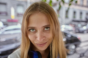 Young caucasian woman walks outdoors.