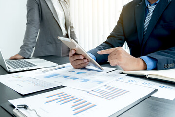 Two business leaders talk about charts, financial graphs showing results are analyzing and calculating planning strategies, business success building processes