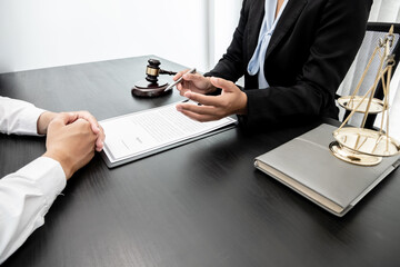 A woman lawyer or a judge counseling clients about judicial justice and prosecution with scales,...