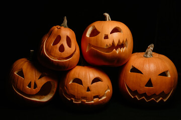 Halloween decor of orange pumpkins with carved faces