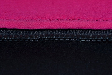 black neoprene fabric with zipper and pink fabric