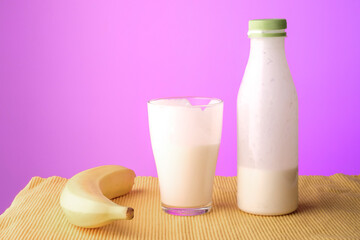 banana and a bottle of kefir on a yellow cloth napkin