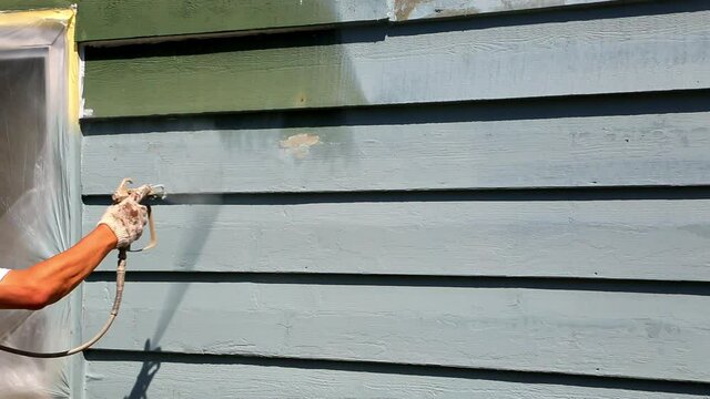 Spray painting house exterior wood siding