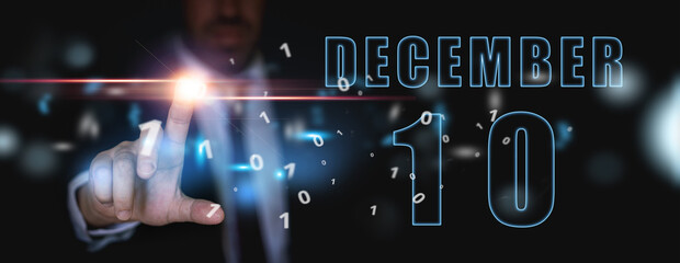 december 10th. Day 10 of month,advertising or high-tech calendar, man in suit presses bright virtual button winter month, day of the year concept