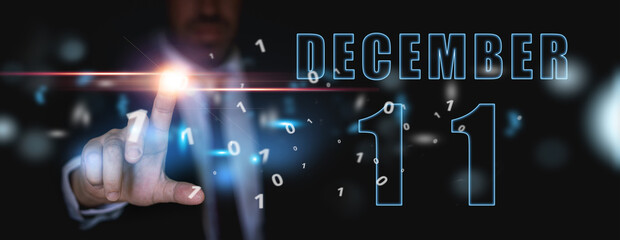december 11th. Day 11 of month,advertising or high-tech calendar, man in suit presses bright virtual button winter month, day of the year concept