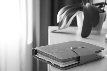 Orange notebook and glasses, clip paper on on financial tables