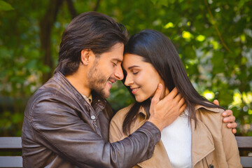 Fototapeta premium Portrait of beautiful couple cuddling in park