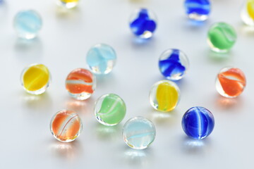 Colorful glass marbles on white background.