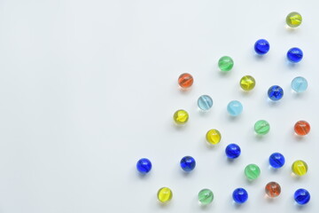 Colorful glass marbles on white background.