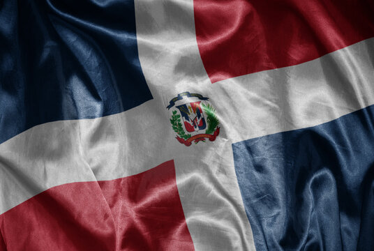 colorful shining big national flag of dominican republic on a silky texture.