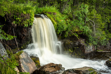 Small waterfall in the middle of a forest in Sweden