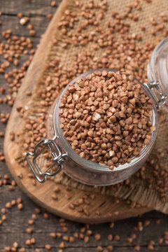 Buckwheat groats on wooden background. Healthy cereal concept. © jeny_lk