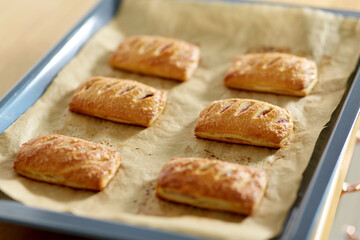 food cooking, culinary and pastry concept - close up of baking tray with jam pies at home kitchen