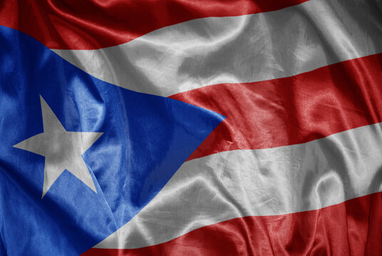 colorful shining big national flag of puerto rico on a silky texture.