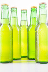 Close up of a row bottles of fresh beer on studio