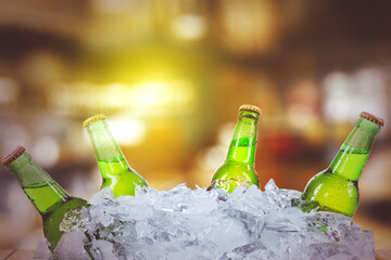 Five fresh beer bottles with blurred light background