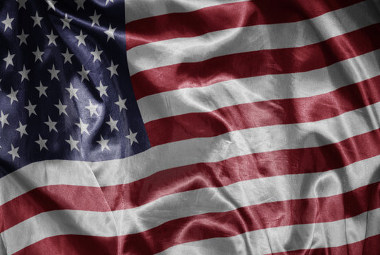 colorful shining big national flag of united states of america on a silky texture.