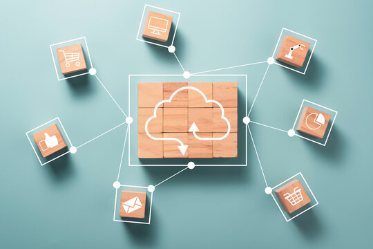 Virtual cloud computing are printed screen on wooden cubes block and connect line with others social media and online shopping icons such as trolley cart , letter , computer.