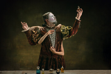 Fall in love. Young man as Johann Bach isolated on dark green background. Retro style, comparison...