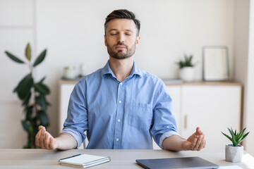 Office Zen. Relaxed Male Entrepreneur Meditating At Workplace, Coping With Work Stress