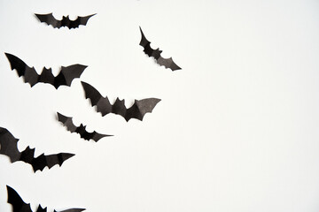 Halloween decoration concept black paper bats white cardboard background