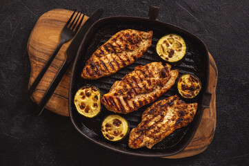 Grilled chicken breasts and zucchini.