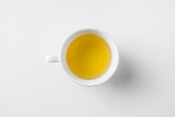 Obraz na płótnie Canvas Top view of cup of hot tea on white background