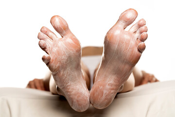 Fototapeta premium Female feet with foot mask on them