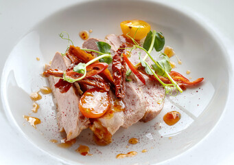 Roasted Duck Meat with Tomatoes, Small Green Sprouts and Sauce.