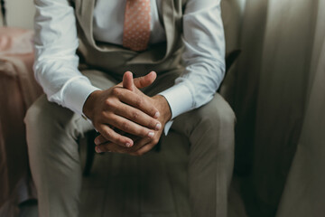 Obraz premium close up of man hands with suit and tie, sitting. Meditation concept, groom or businessman.