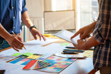 Two designers plan and draw the design of the website.