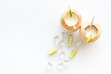 Raw coconut water or milk with straw, above view