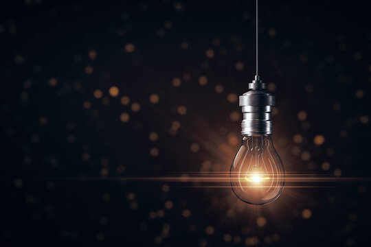 Creative glowing light bulb on gray background.