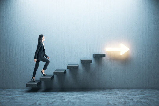 Young businesswoman moving up on stairs with arrow
