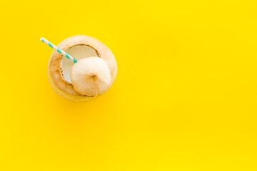 Raw coconut water or milk with straw, above view