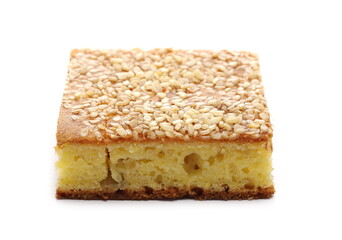 Cornbread slice with sesame seeds, traditional breakfast pastry isolated on white background