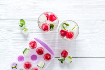 Raspberry and lime in ice cubes top view flat lay
