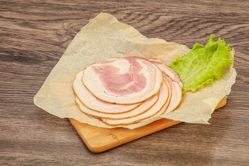 Sliced Pancetta sausage over board