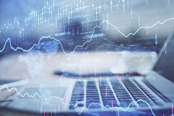 Naklejka premium Financial market graph hologram and personal computer on background. Double exposure. Concept of forex.