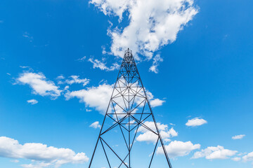 Old metal tower on blue sky background.