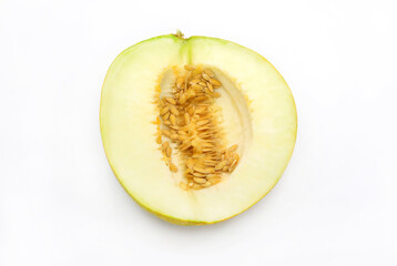 Cut melon with seeds close-up on white background