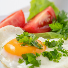 Food poster - Healthy and hearty breakfast. Close-up of a fried eggs, tomato, herbs and espresso coffee. Served on a white table with a linen napkin and cutlery.
