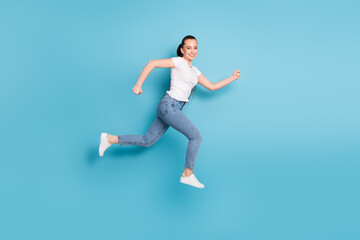 Fototapeta na wymiar Full body profile side photo of charming girl jump run copyspace after season discounts wear good look outfit isolated over blue color background