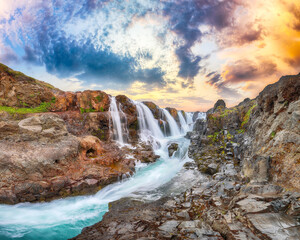 Dramaic view of  Kolufossar waterfall at sunset.