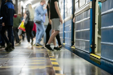 People get off the train car in the subway