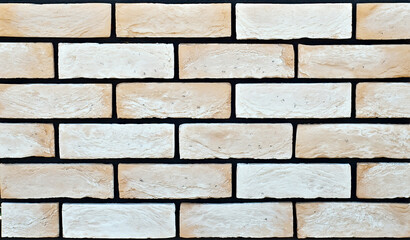 Obraz premium Texture of brick wall. new brickwork. Samples of wall or fence are presented at exhibitions. Yellow brick close up.
