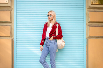 Stylish female leaning on wall