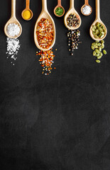 Asian and Indian spices and herbs in wooden spoons for cooking