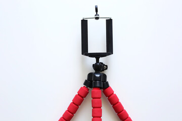Mobile phone and tripod on white background.Smart phone new technology dedicated for live streaming. Blogger equipment.