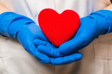 Hands in Glove Holding a Heart